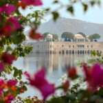 Restored Water Palace in Sagar Lake, Jaipur City, state of Rajasthan, India featuring Rajput and Mughal styles of architecture made of red sandstone.